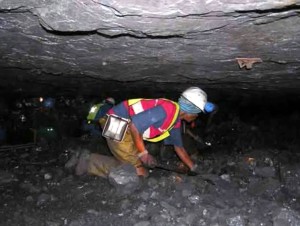 Coal miners crawl in mines no taller than a table top